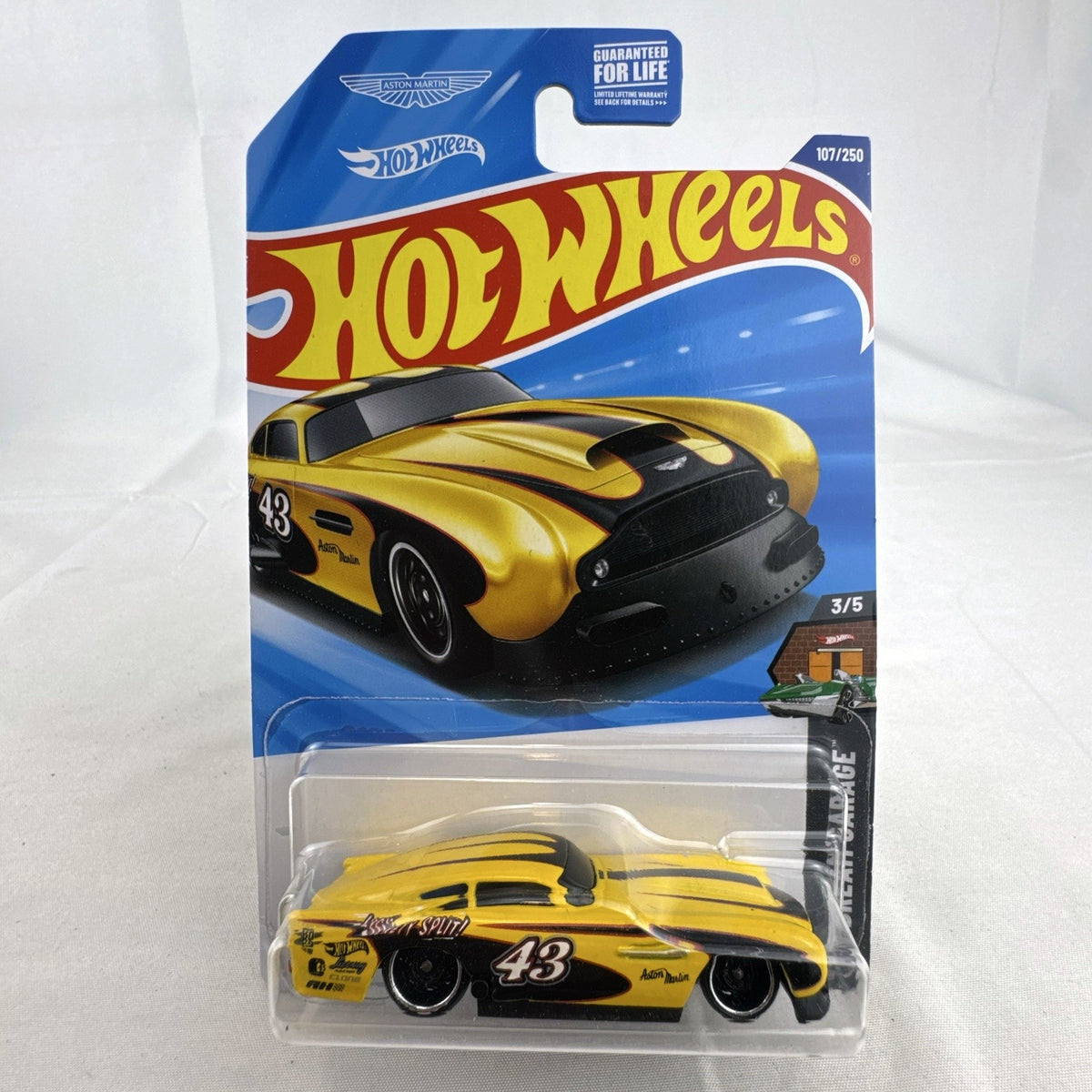 Hot Wheels 1:64 scale yellow Aston Martin DB4GT High-Speed Edition diecast car sealed in original packaging.