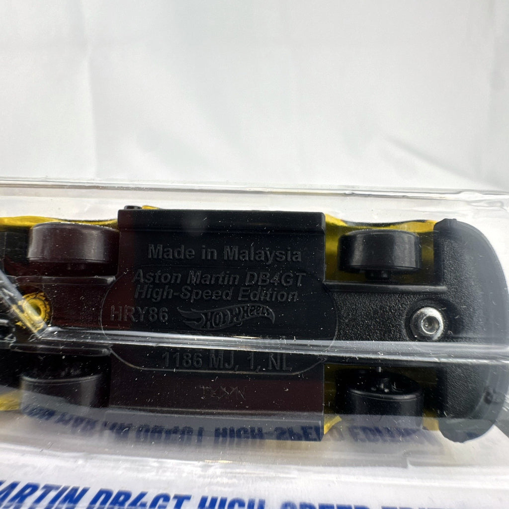 Hot Wheels 1:64 scale yellow Aston Martin DB4GT High-Speed Edition diecast car sealed in original packaging.