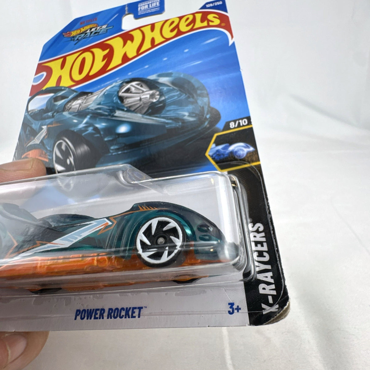Sealed 2024 Hot Wheels Power Rocket 1:64 scale diecast car in translucent teal blue X-Raycers blister card packaging.