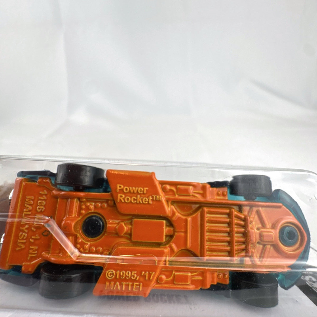 Sealed 2024 Hot Wheels Power Rocket 1:64 scale diecast car in translucent teal blue X-Raycers blister card packaging.