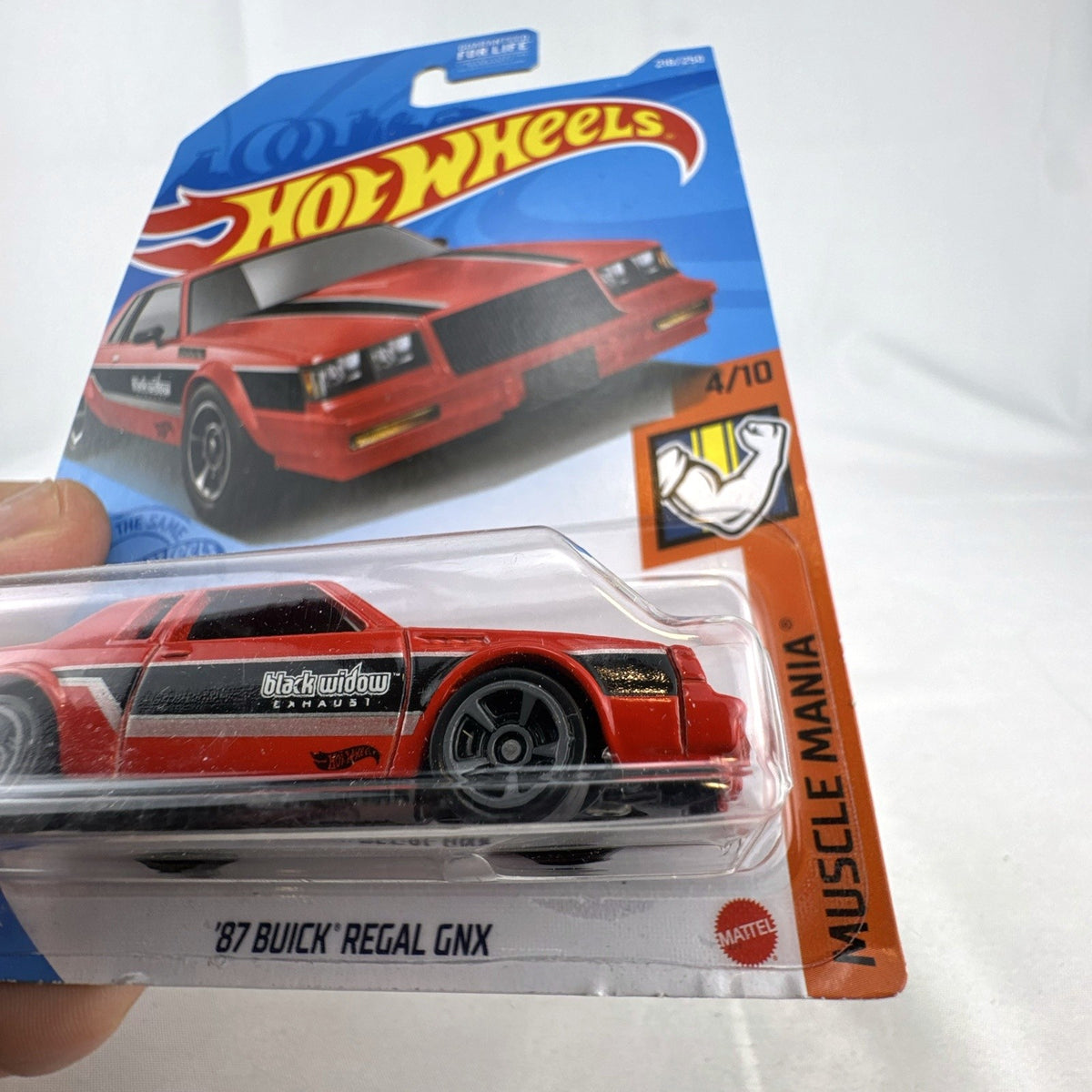 Hot Wheels 1:64 scale 1987 Buick Regal GNX diecast car in red with Black Widow graphics, unopened in original blister pack.