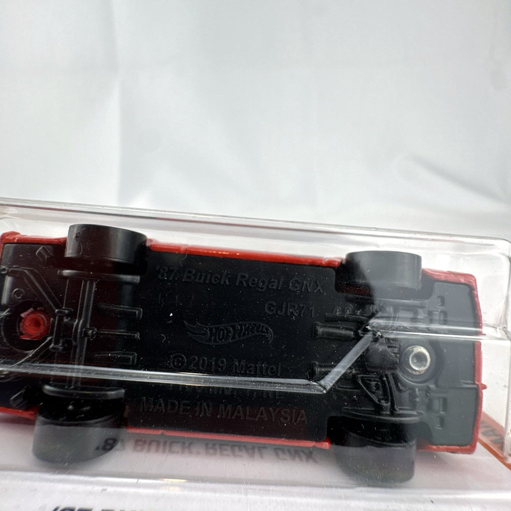Hot Wheels 1:64 scale 1987 Buick Regal GNX diecast car in red with Black Widow graphics, unopened in original blister pack.