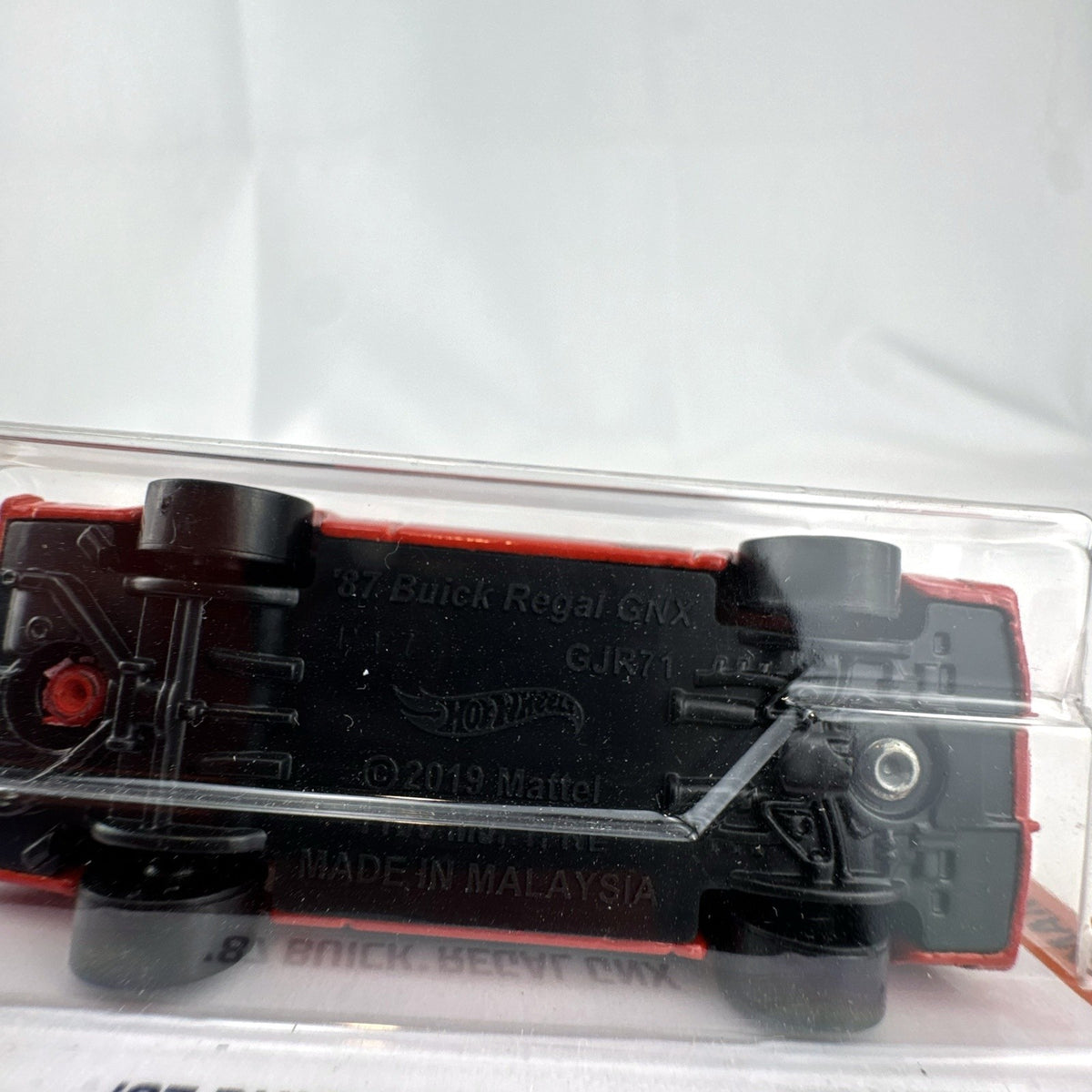 Hot Wheels 1:64 scale 1987 Buick Regal GNX diecast car in red with Black Widow graphics, unopened in original blister pack.