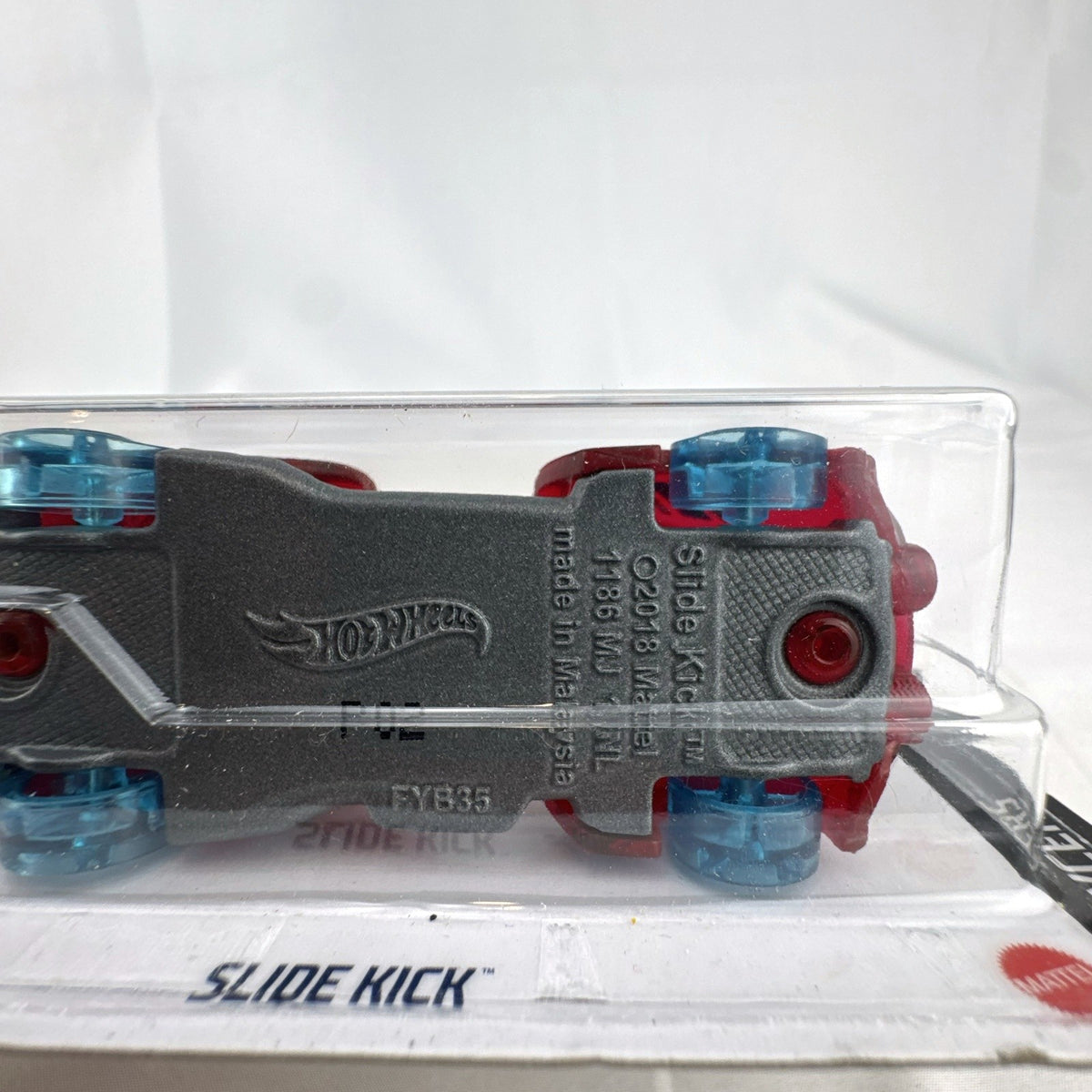 Sealed 2021 Hot Wheels Slide Kick 1:64 diecast car in translucent red from the X-Raycers series.