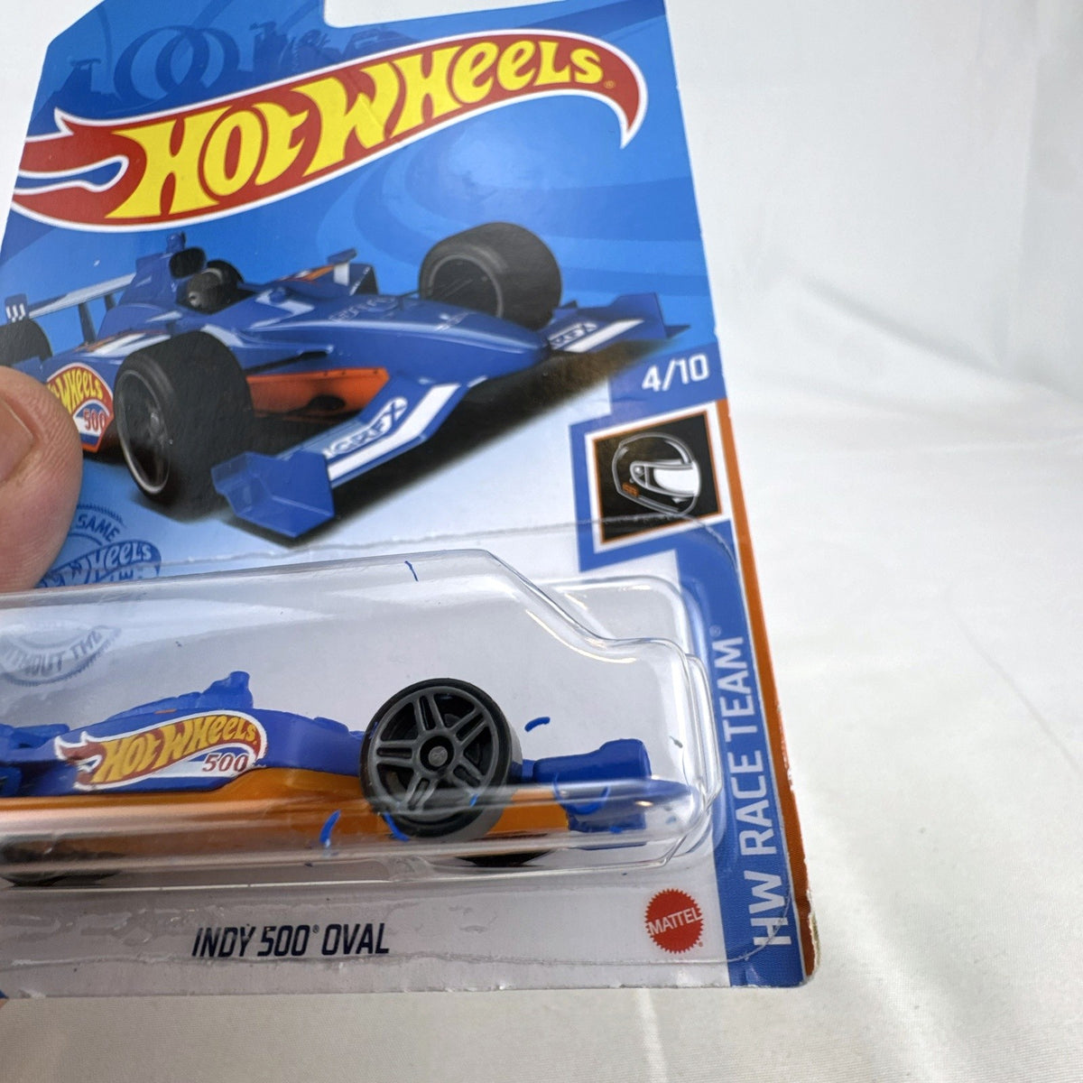 Hot Wheels 1:64 scale Indy 500 Oval race car in blue HW Race Team livery, factory sealed on original card package.