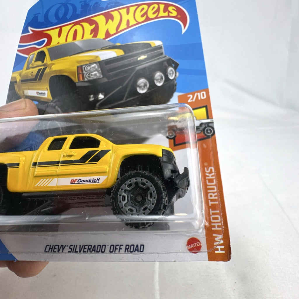 Hot Wheels 1:64 scale Chevy Silverado Off Road diecast truck in yellow, sealed on original blister card