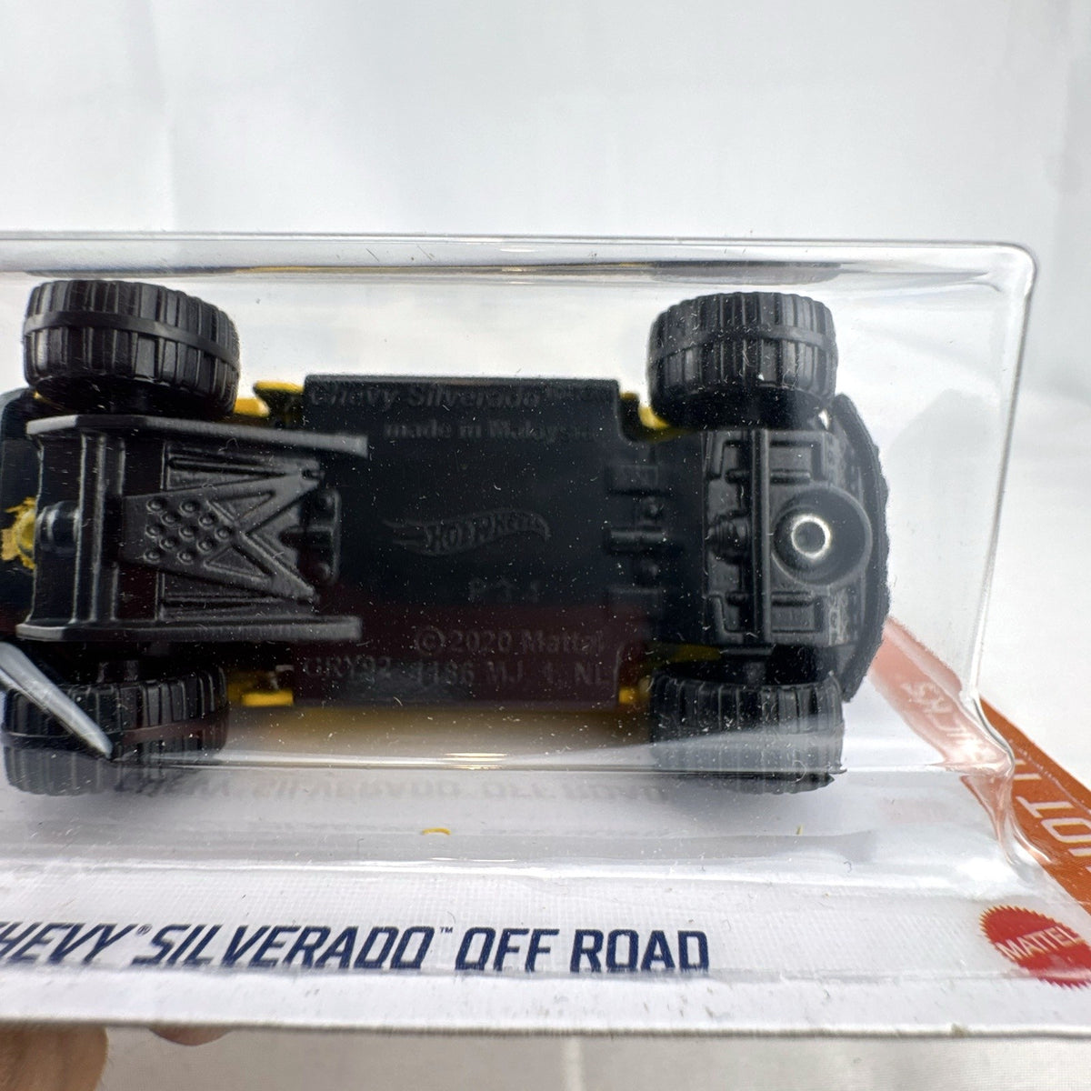 Hot Wheels 1:64 scale Chevy Silverado Off Road diecast truck in yellow, sealed on original blister card