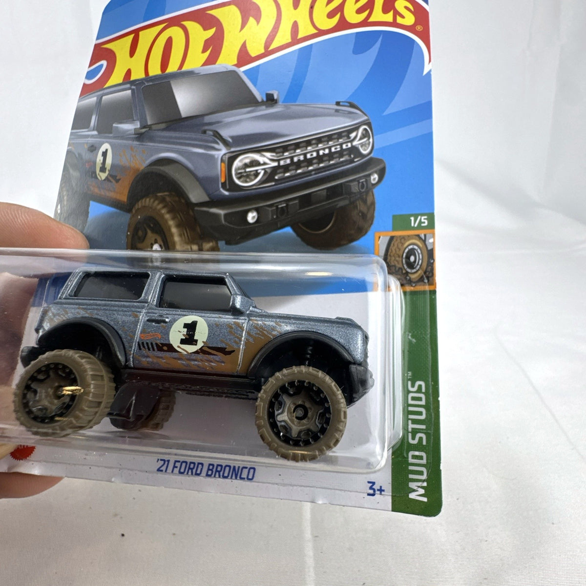 Hot Wheels 2021 Ford Bronco diecast SUV in gray with Mud Studs off-road graphics sealed on blister card