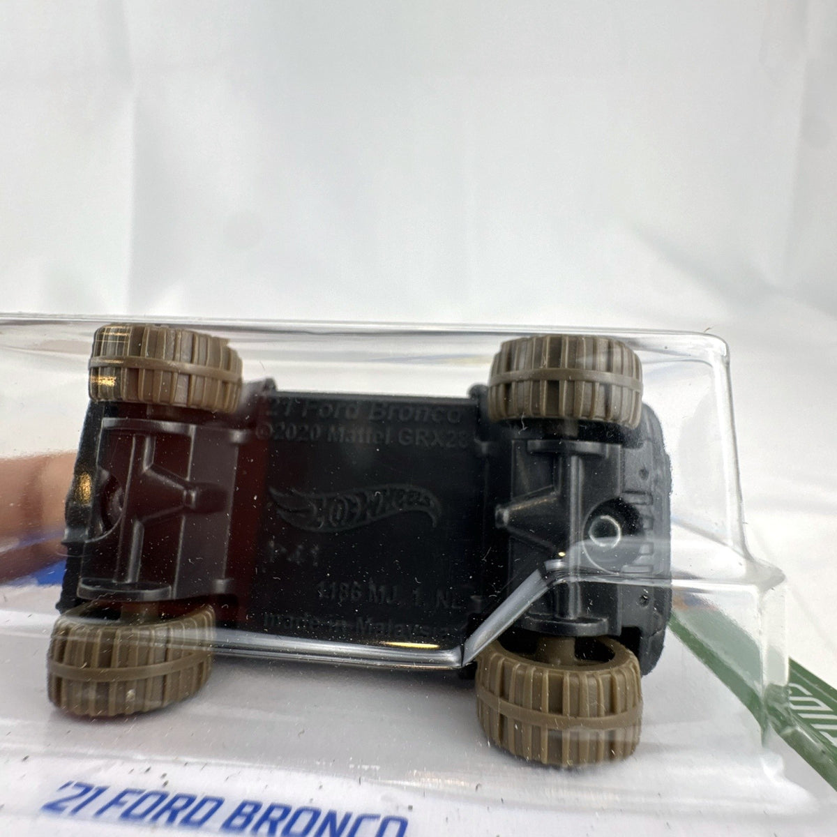 Hot Wheels 2021 Ford Bronco diecast SUV in gray with Mud Studs off-road graphics sealed on blister card
