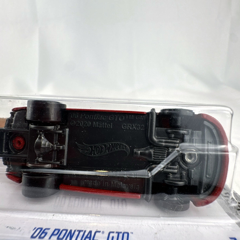 Hot Wheels 1:64 scale red '06 Pontiac GTO HW Drag Strip series diecast car in factory sealed blister package