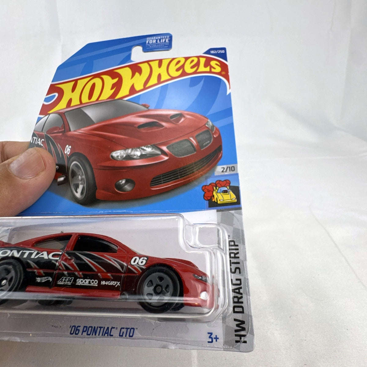 Hot Wheels 1:64 scale red '06 Pontiac GTO HW Drag Strip series diecast car in factory sealed blister package