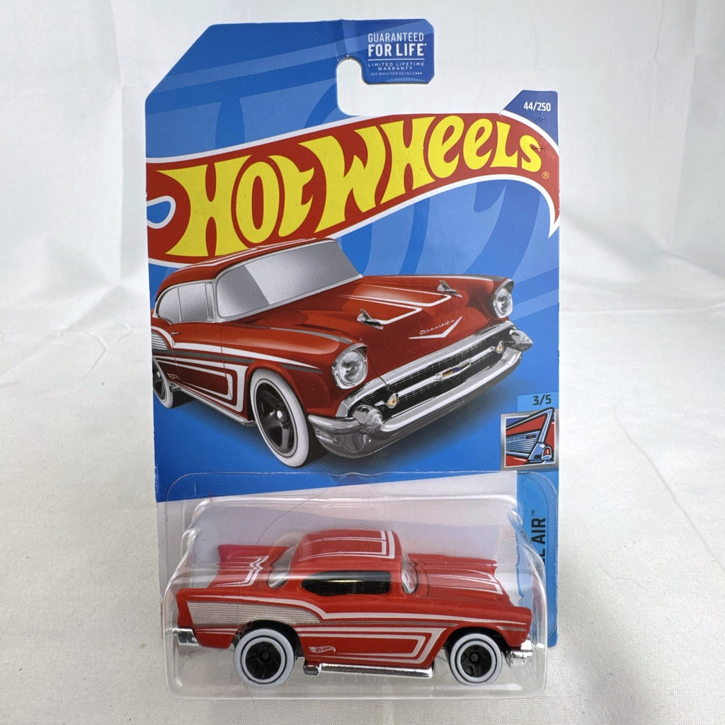 Hot Wheels 1:64 scale 1957 Chevrolet Bel Air diecast car in red with whitewall tires sealed on blister card