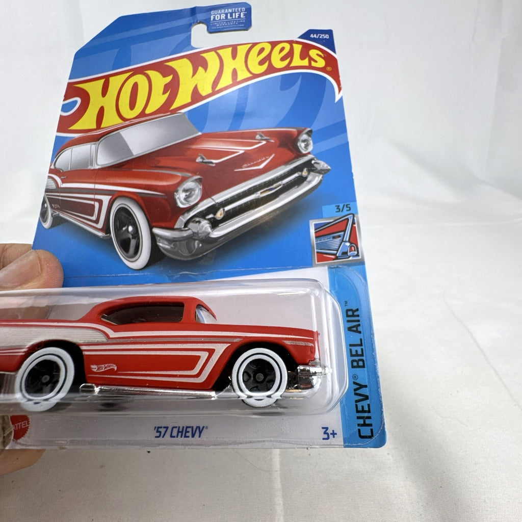 Hot Wheels 1:64 scale 1957 Chevrolet Bel Air diecast car in red with whitewall tires sealed on blister card