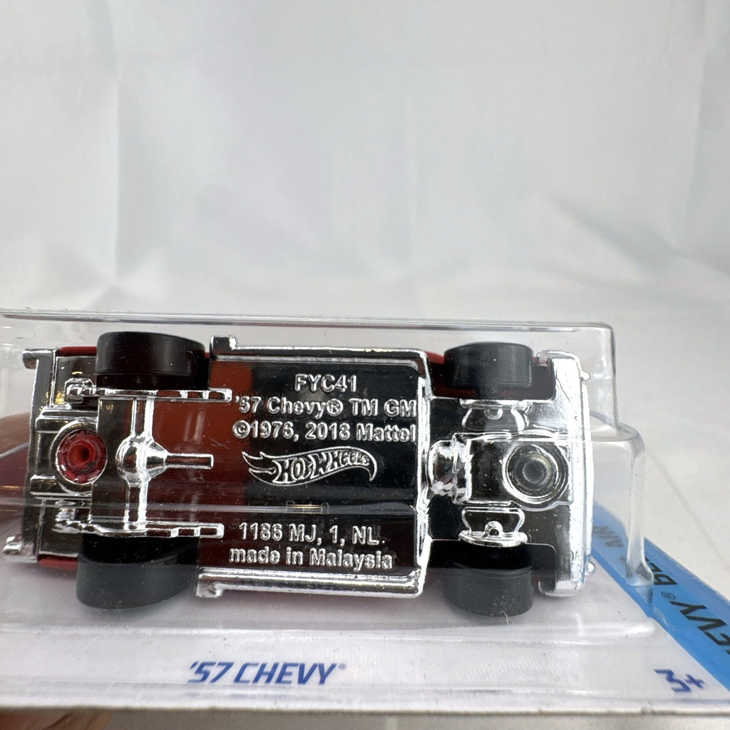 Hot Wheels 1:64 scale 1957 Chevrolet Bel Air diecast car in red with whitewall tires sealed on blister card
