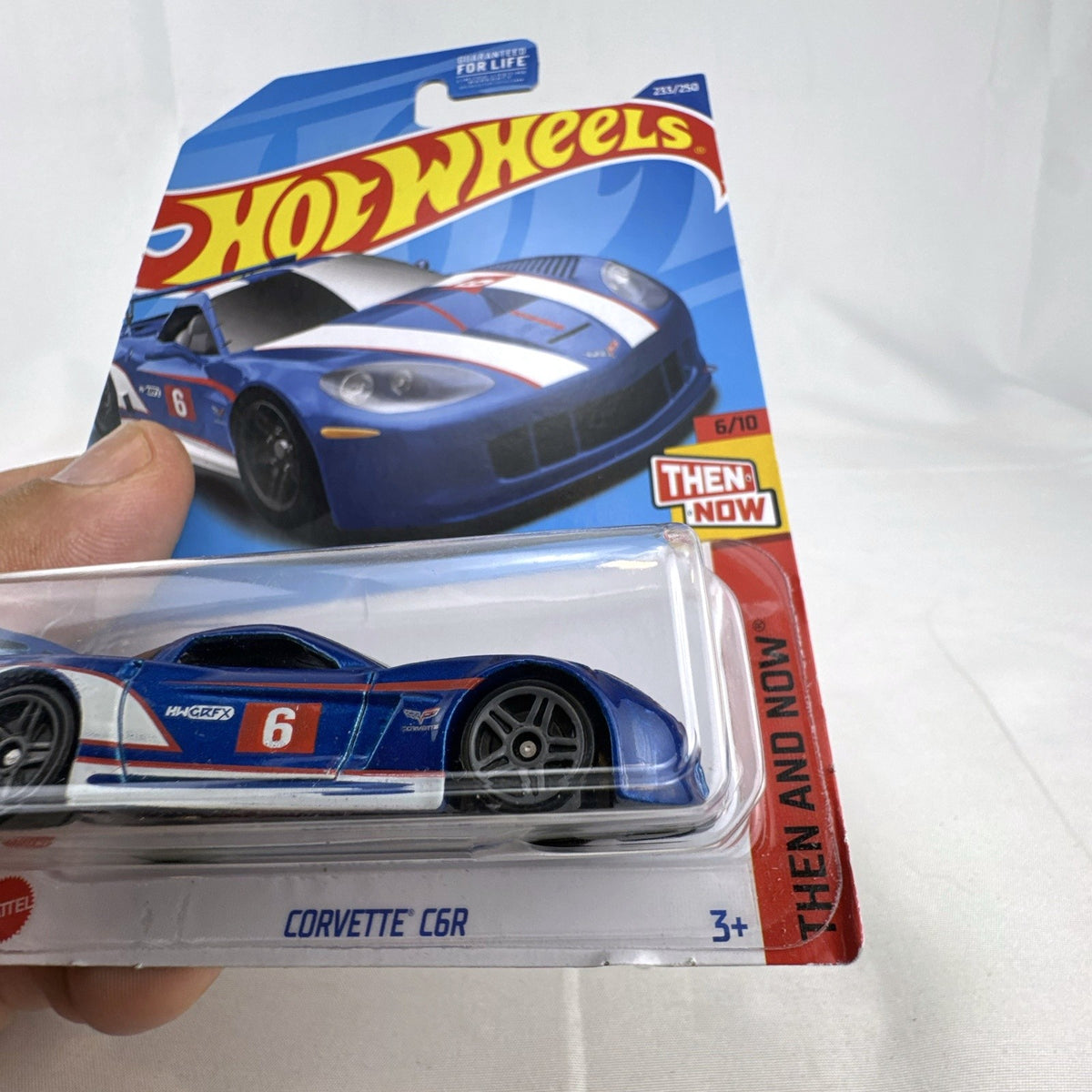 Hot Wheels 1:64 scale blue Chevrolet Corvette C6R diecast racing car sealed in original packaging.
