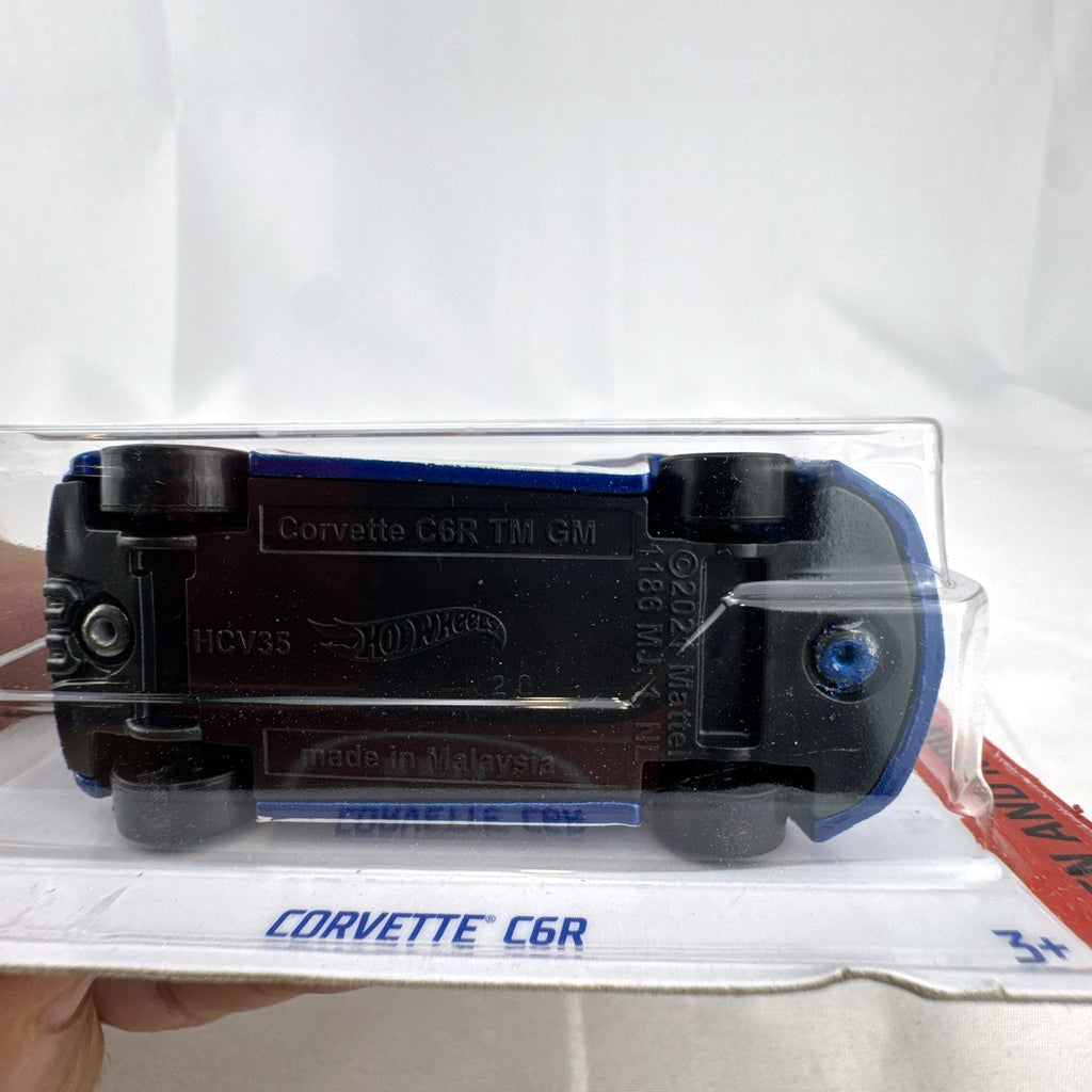 Hot Wheels 1:64 scale blue Chevrolet Corvette C6R diecast racing car sealed in original packaging.