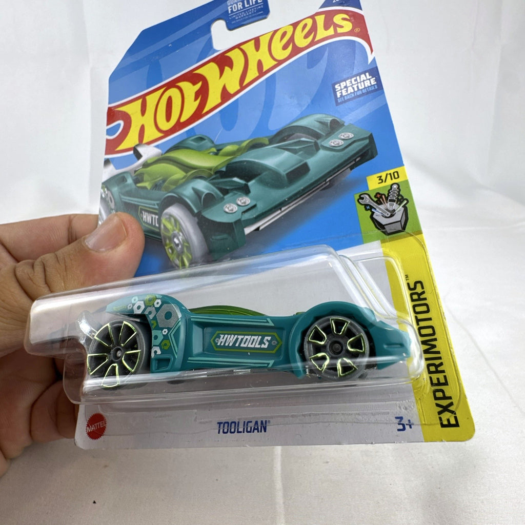 Sealed 1:64 scale Hot Wheels Tooligan diecast car in teal green from the 2022 Experimotors series.