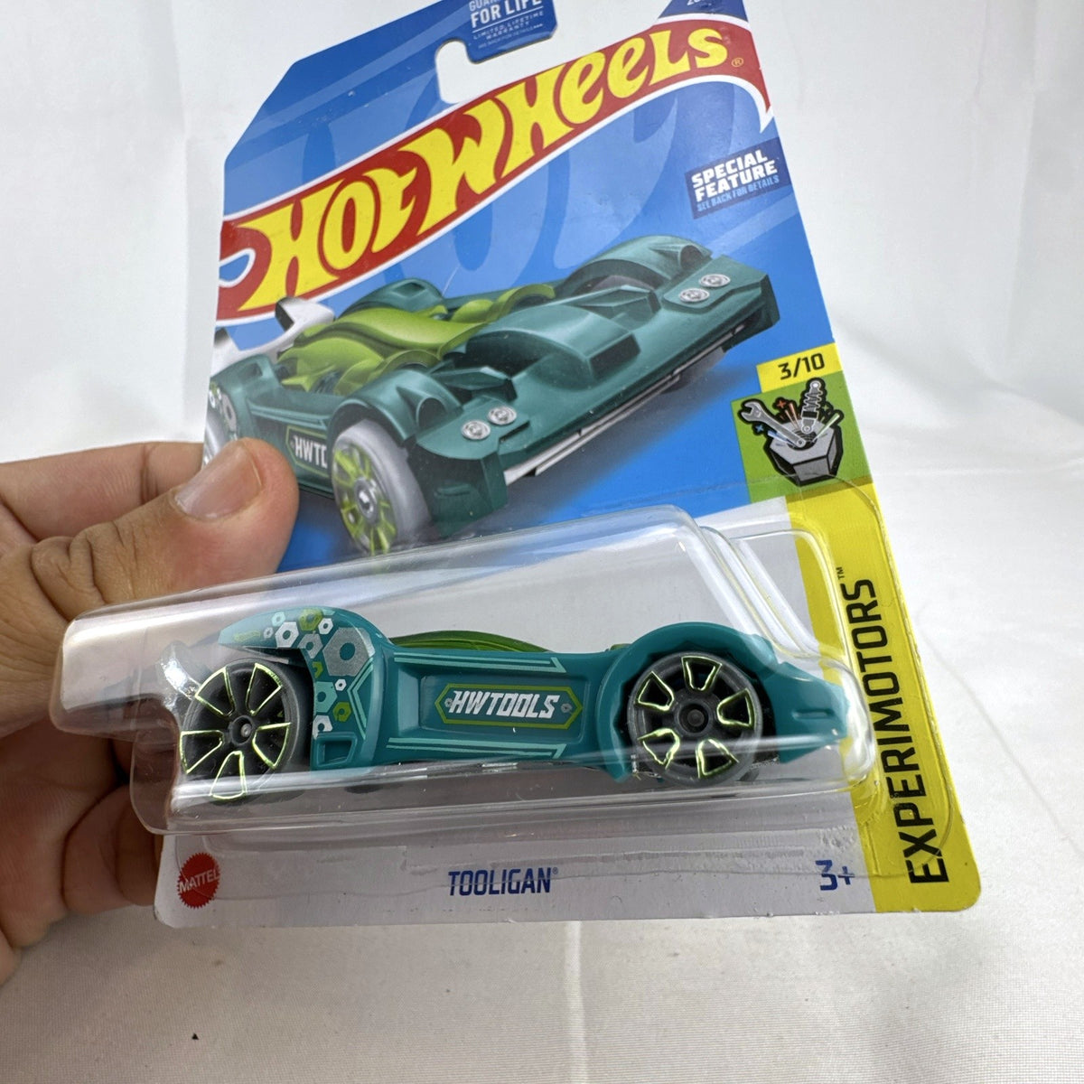 Sealed 1:64 scale Hot Wheels Tooligan diecast car in teal green from the 2022 Experimotors series.