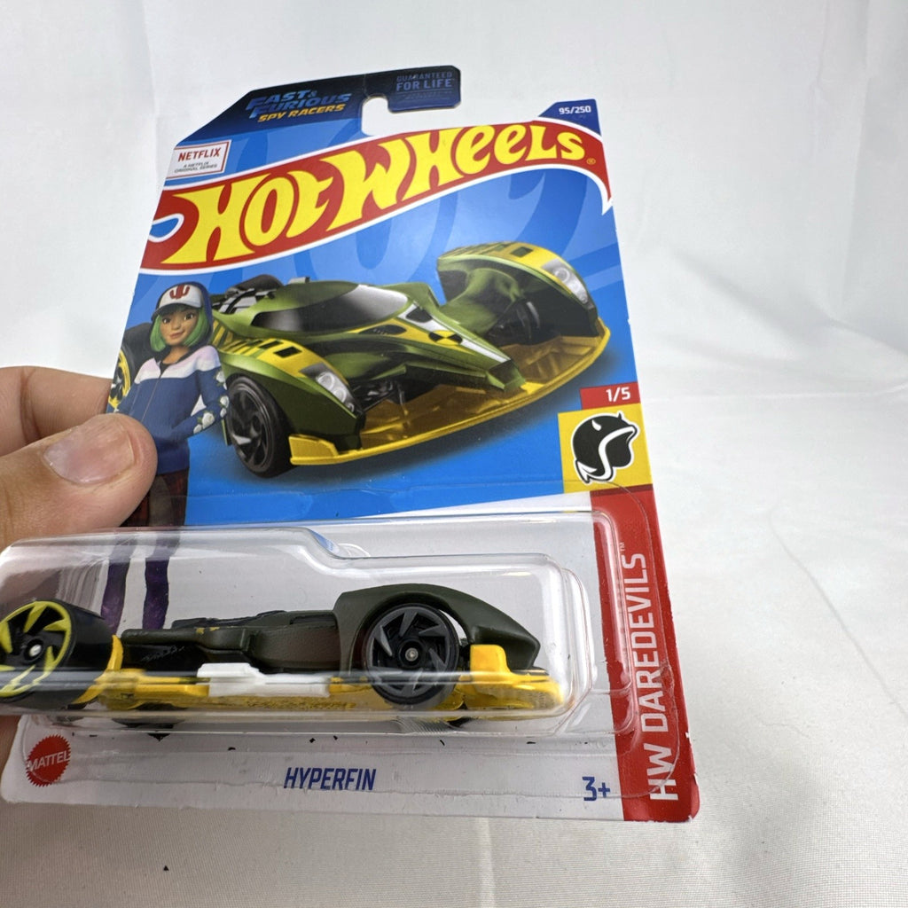 Hot Wheels Hyperfin 1:64 diecast stunt car in olive green and yellow on original unopened card.