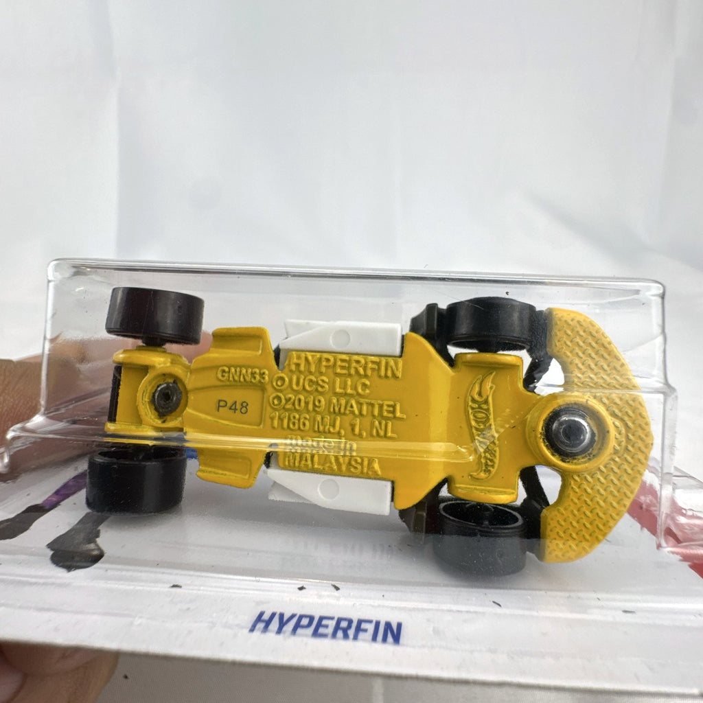 Hot Wheels Hyperfin 1:64 diecast stunt car in olive green and yellow on original unopened card.
