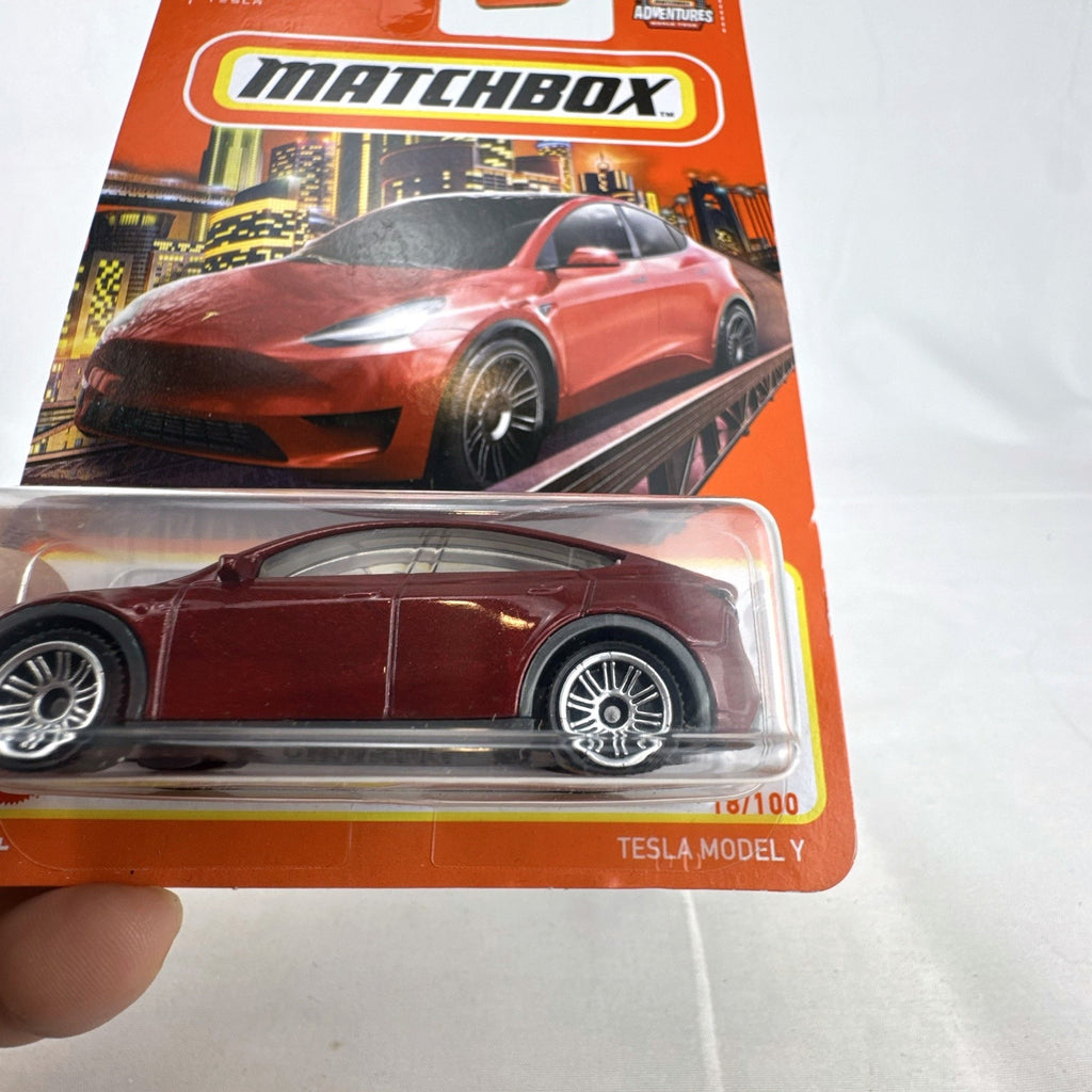 Matchbox 1:64 scale Tesla Model Y diecast toy car in deep metallic red, factory sealed on original card.