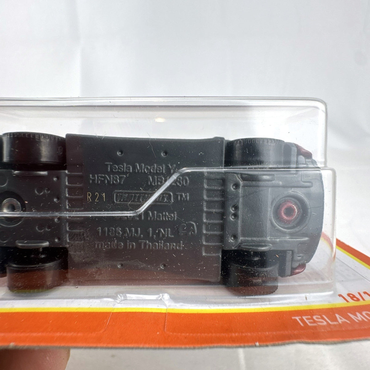 Matchbox 1:64 scale Tesla Model Y diecast toy car in deep metallic red, factory sealed on original card.