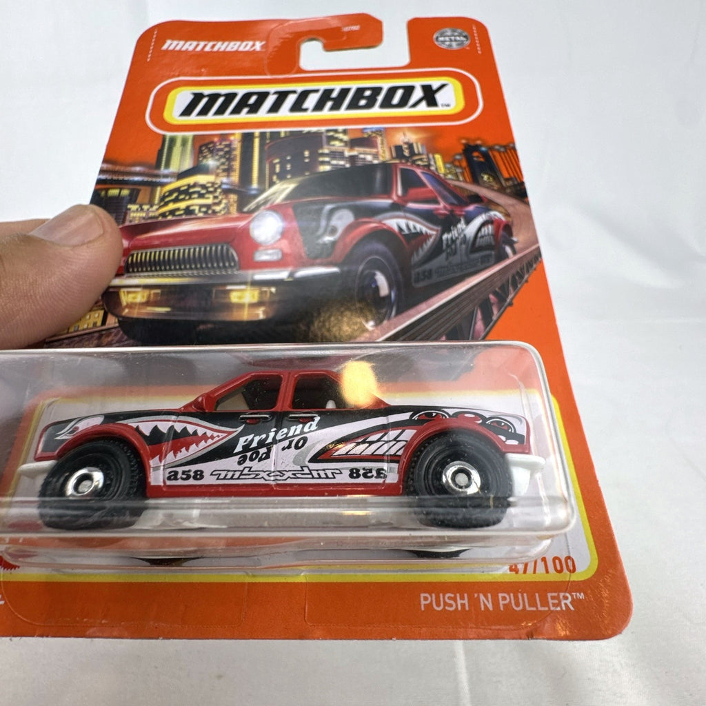 Red Matchbox Push 'N Puller 1:64 scale diecast truck with shark mouth graphics, sealed in original packaging.