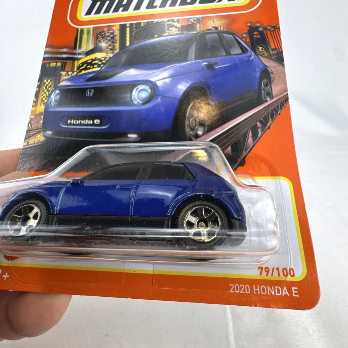 Matchbox 1:64 scale diecast model of a blue 2020 Honda e EV in original unopened blister card packaging.