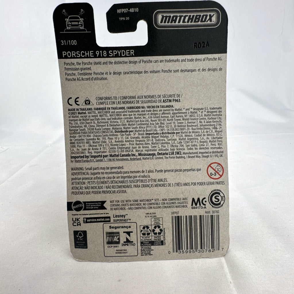 Matchbox 1:64 scale Porsche 918 Spyder diecast car in dark metallic grey with gold rims sealed on original card