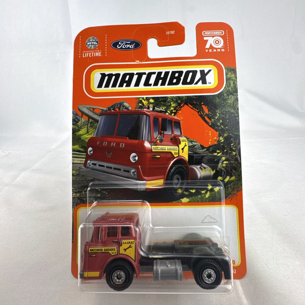 Sealed Matchbox 1:64 scale 1965 Ford C900 diecast truck in red with Matchbox Garages graphics.