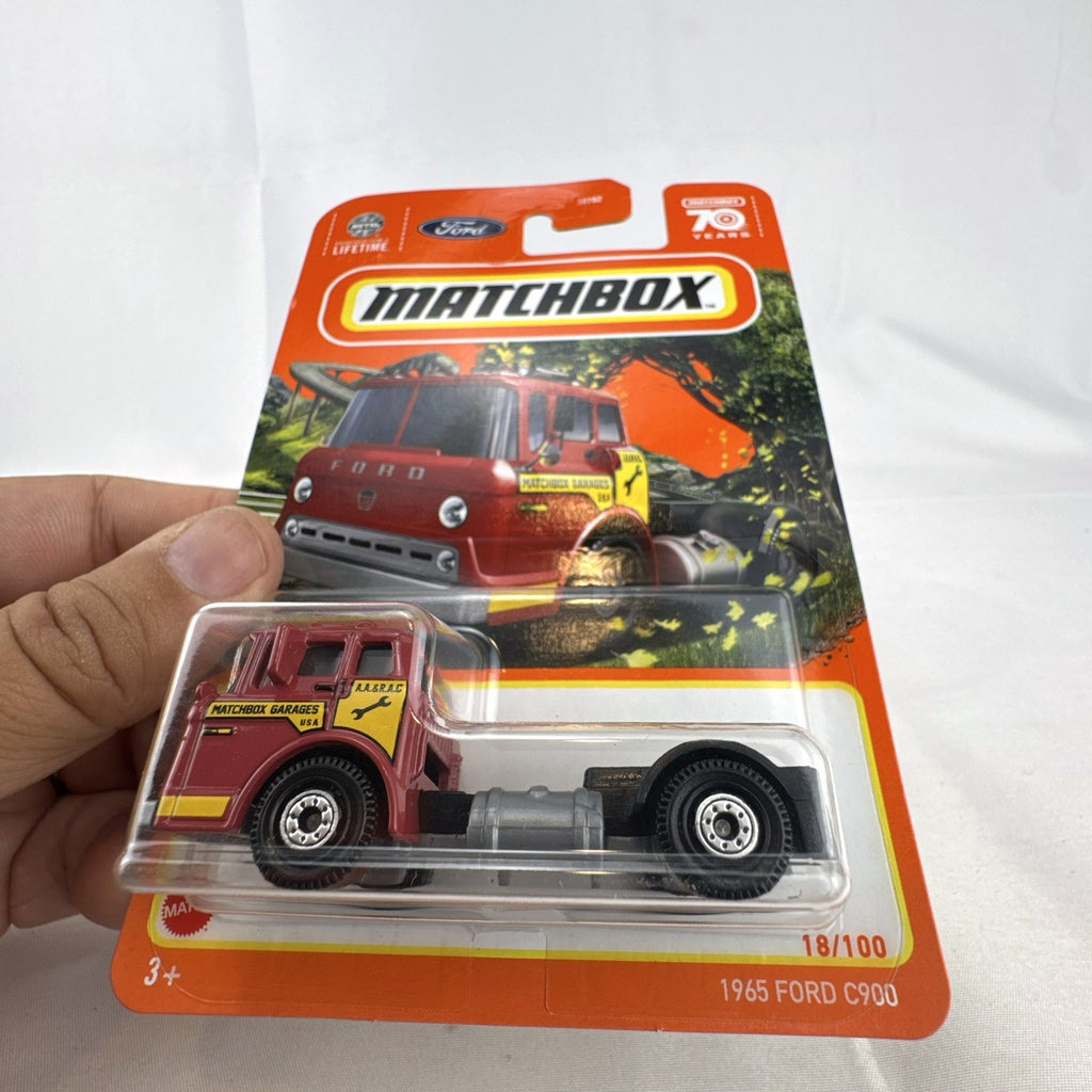 Sealed Matchbox 1:64 scale 1965 Ford C900 diecast truck in red with Matchbox Garages graphics.