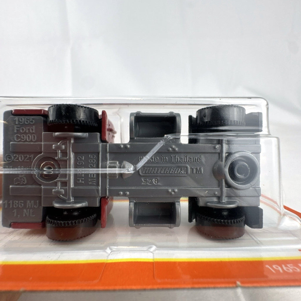 Sealed Matchbox 1:64 scale 1965 Ford C900 diecast truck in red with Matchbox Garages graphics.