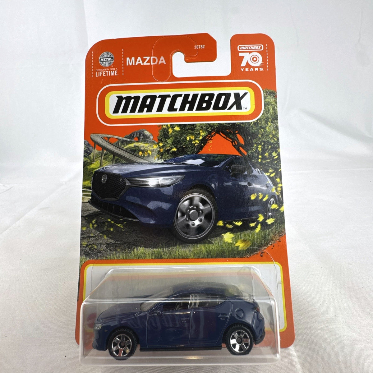 Matchbox 1:64 scale 2019 Mazda 3 Hatchback diecast car in deep blue, factory sealed on original 70th Anniversary card.