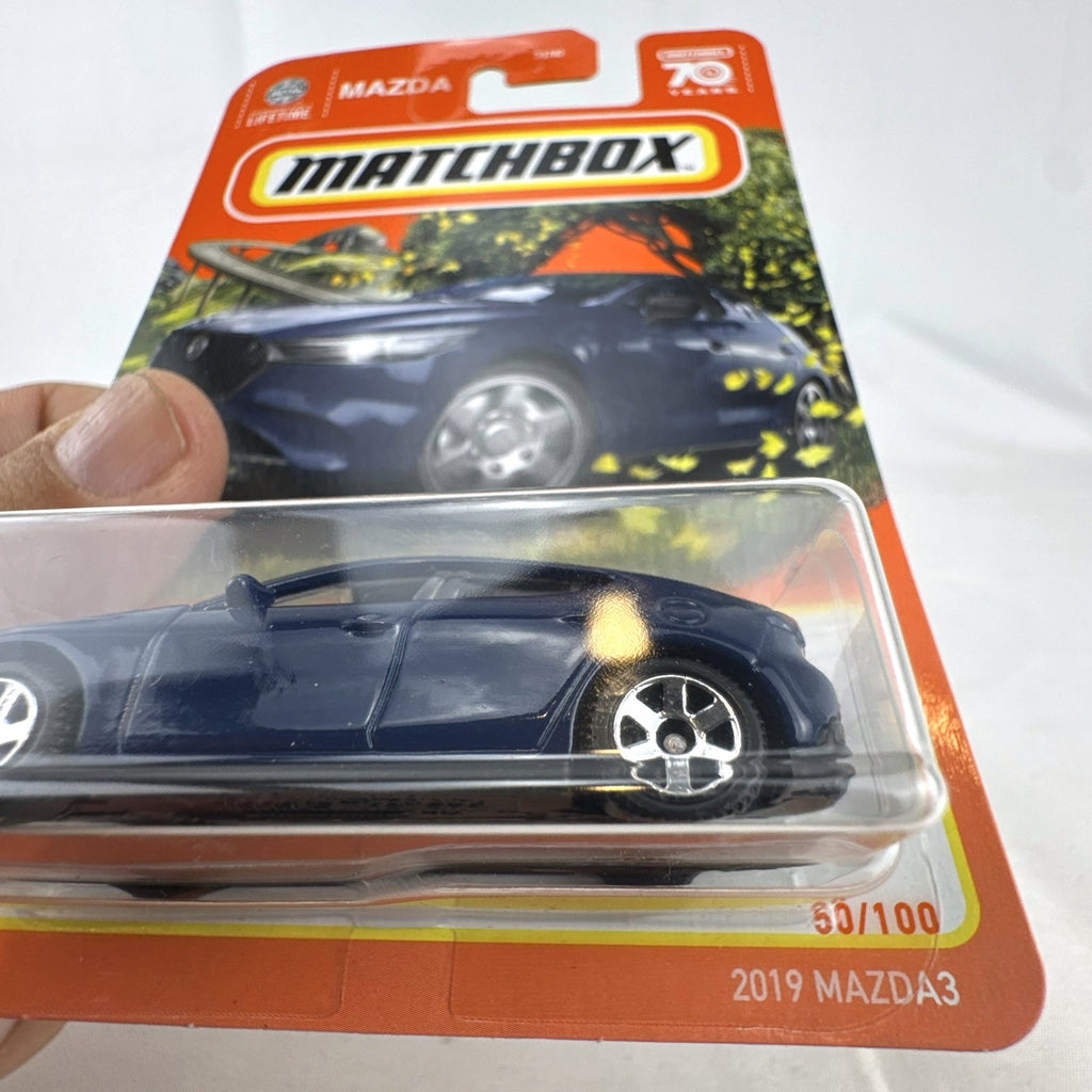 Matchbox 1:64 scale 2019 Mazda 3 Hatchback diecast car in deep blue, factory sealed on original 70th Anniversary card.