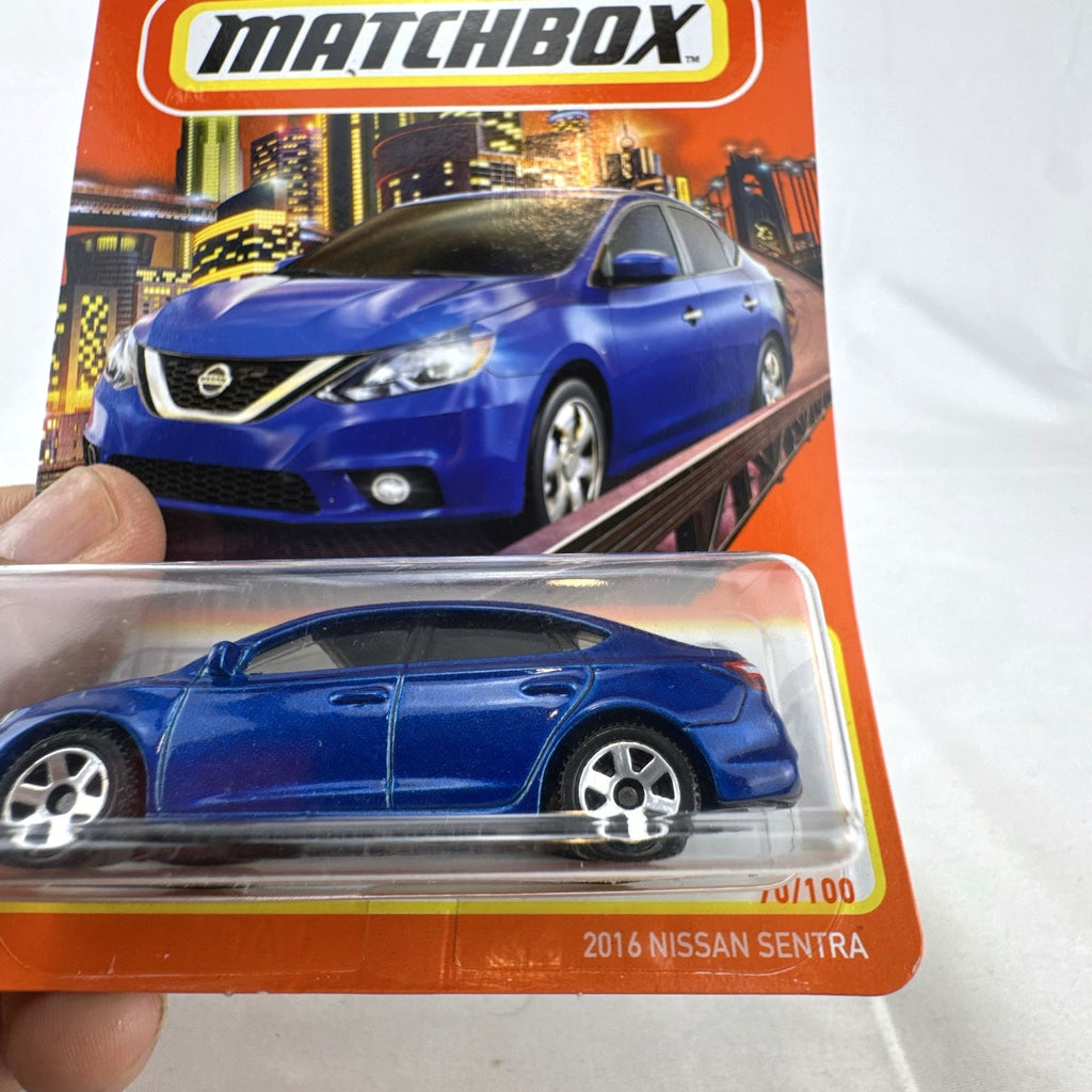 Matchbox 1:64 scale 2016 Nissan Sentra diecast car in metallic blue 70th Anniversary carded packaging
