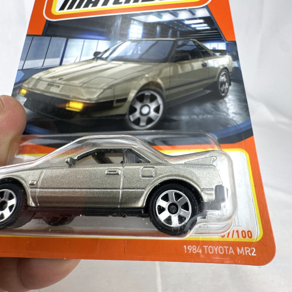 Matchbox 1:64 scale 1984 Toyota MR2 diecast car in metallic gold, factory sealed on card.