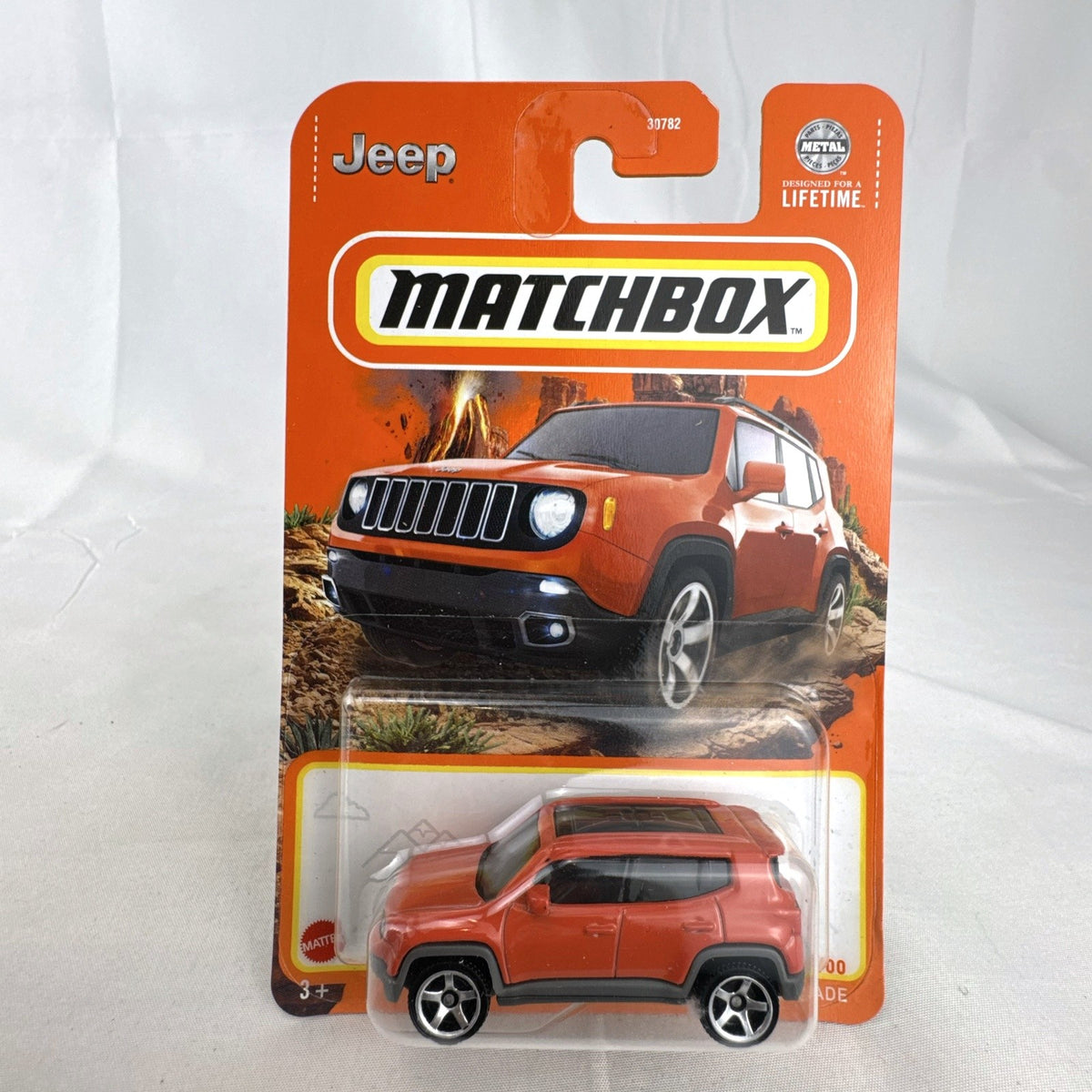 Matchbox 1:64 scale 2019 Jeep Renegade diecast SUV in bright orange, factory sealed on card.