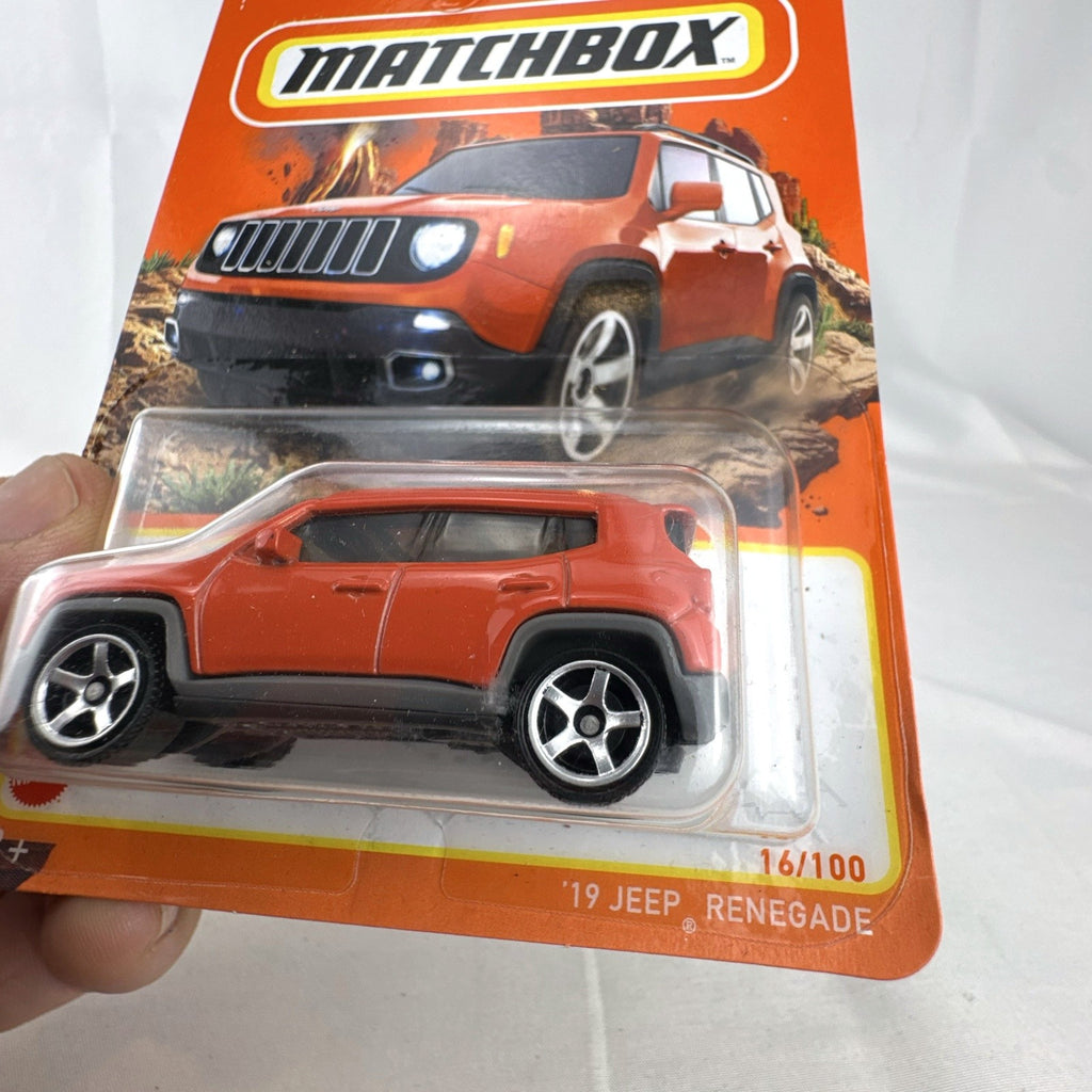 Matchbox 1:64 scale 2019 Jeep Renegade diecast SUV in bright orange, factory sealed on card.