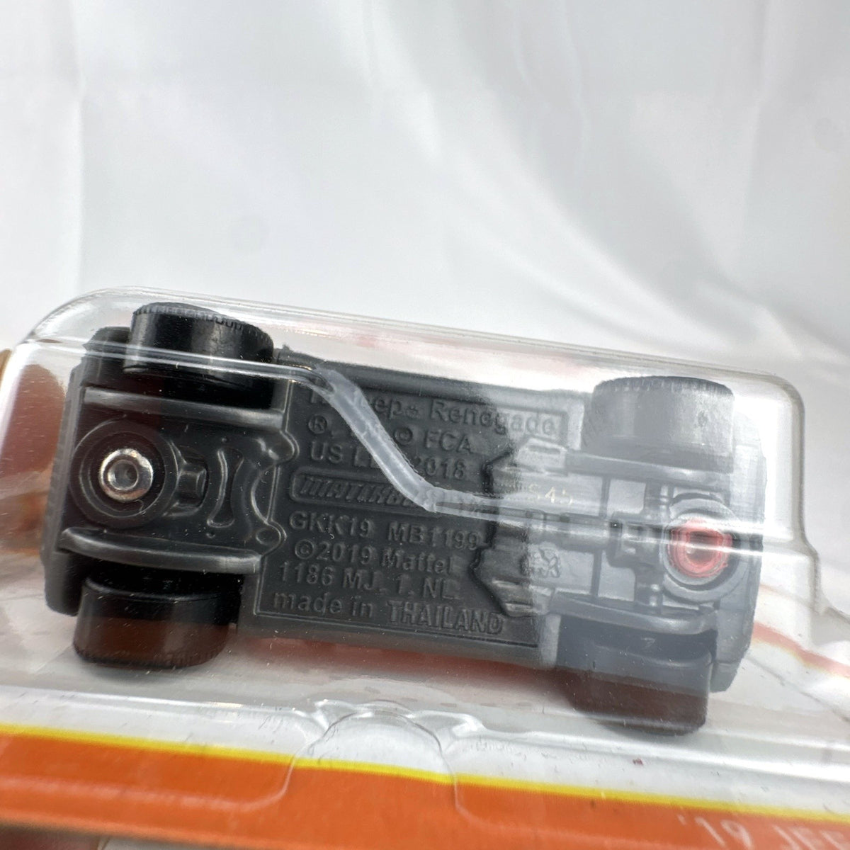 Matchbox 1:64 scale 2019 Jeep Renegade diecast SUV in bright orange, factory sealed on card.