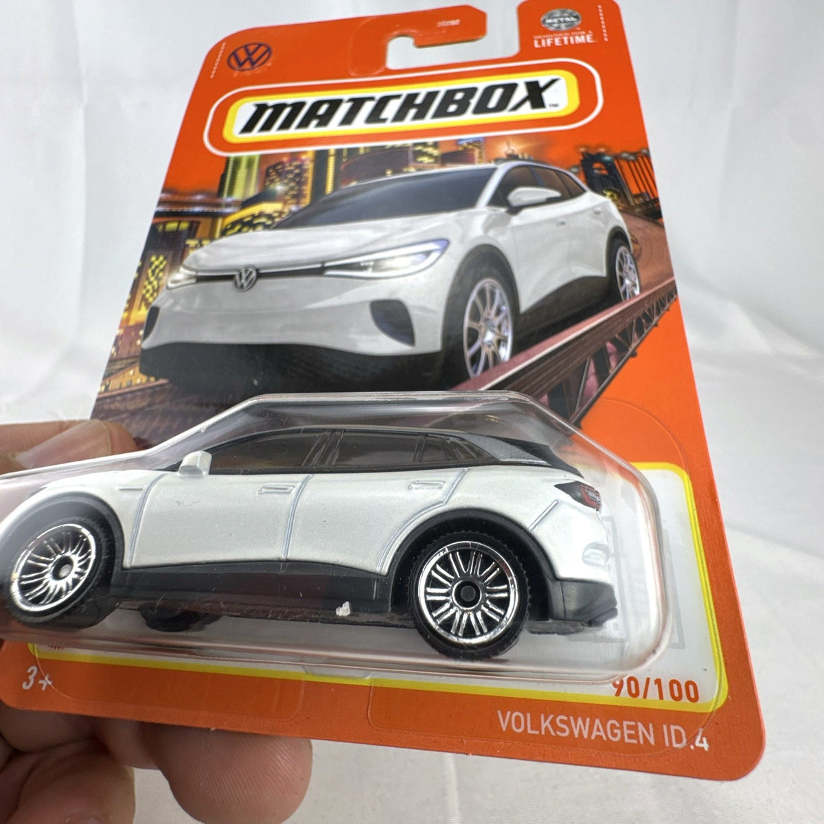 Factory sealed Matchbox 1:64 scale Volkswagen ID.4 diecast electric SUV in white on original packaging card.