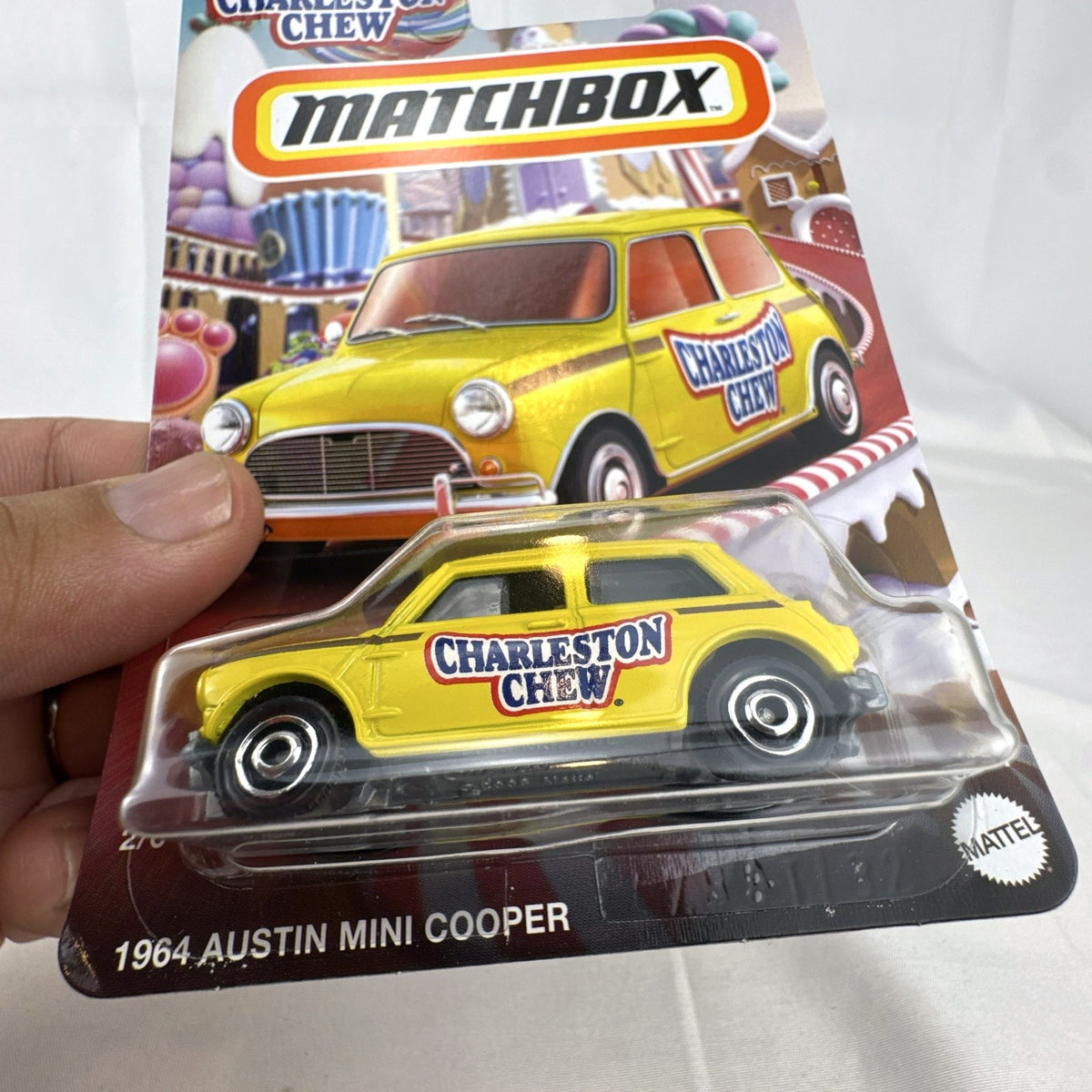 Matchbox 1:64 scale 1964 Austin Mini Cooper in yellow with Charleston Chew Tootsie Roll graphics sealed on card