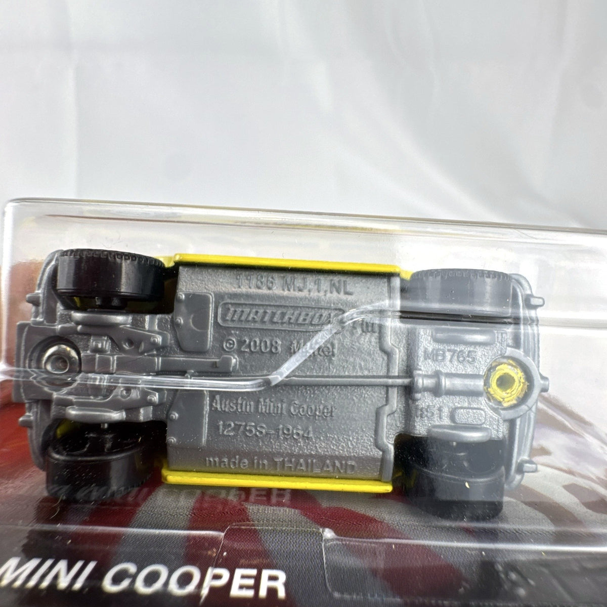 Matchbox 1:64 scale 1964 Austin Mini Cooper in yellow with Charleston Chew Tootsie Roll graphics sealed on card