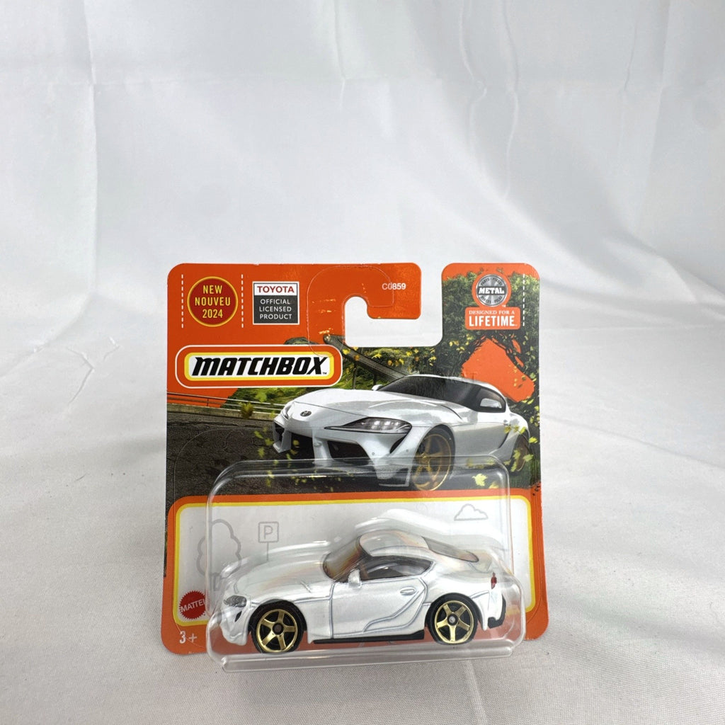 Matchbox 1:64 scale 2023 Toyota GR Supra diecast car in pearl white with gold wheels unopened on original card