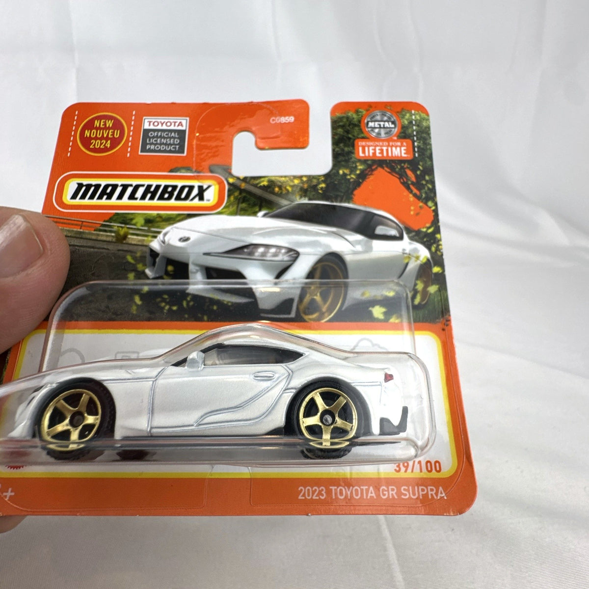 Matchbox 1:64 scale 2023 Toyota GR Supra diecast car in pearl white with gold wheels unopened on original card