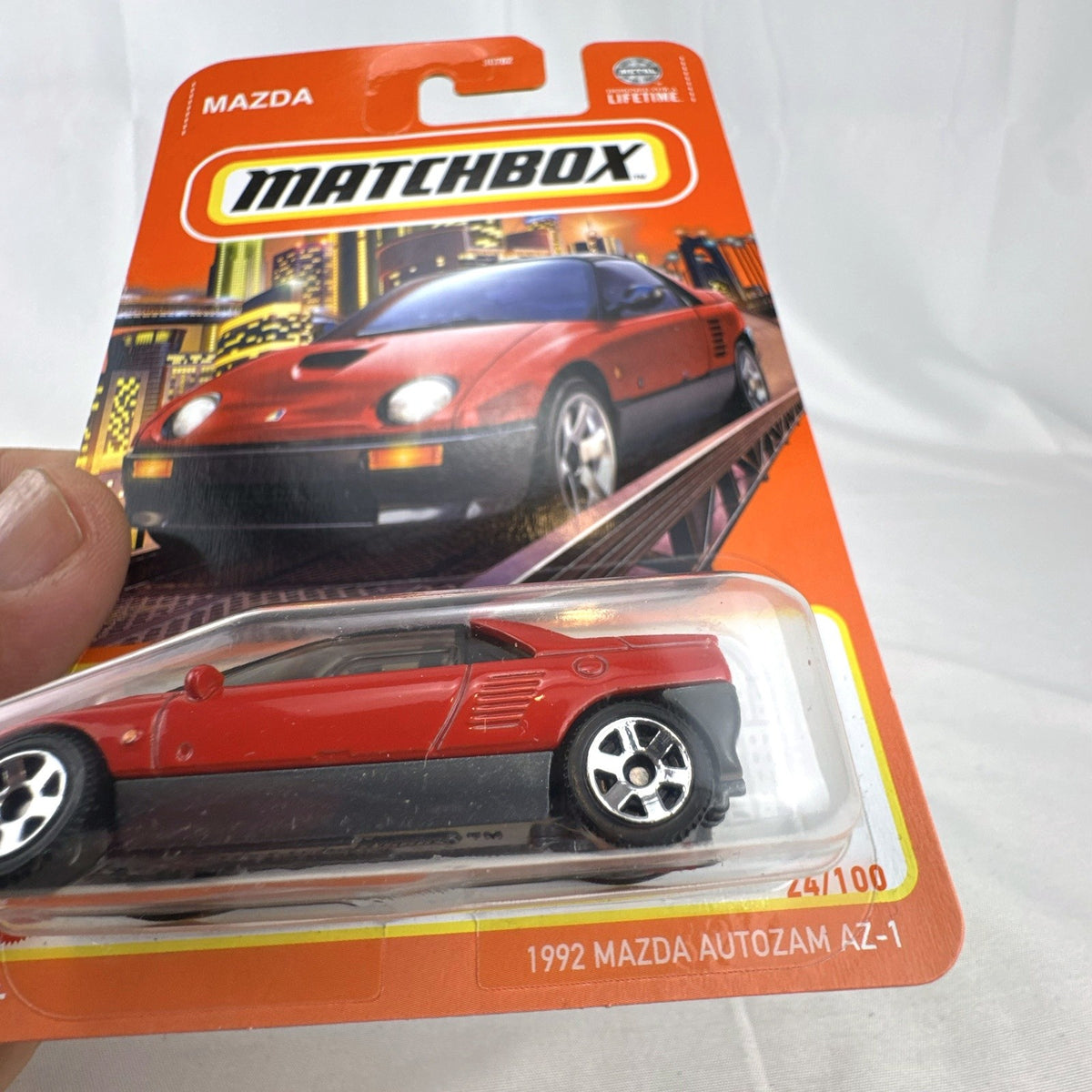 Matchbox 1992 Mazda Autozam AZ-1 diecast car in red, sealed on original blister card, 1:64 scale.