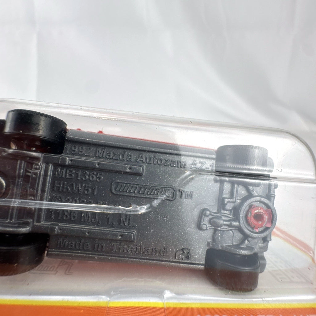 Matchbox 1992 Mazda Autozam AZ-1 diecast car in red, sealed on original blister card, 1:64 scale.
