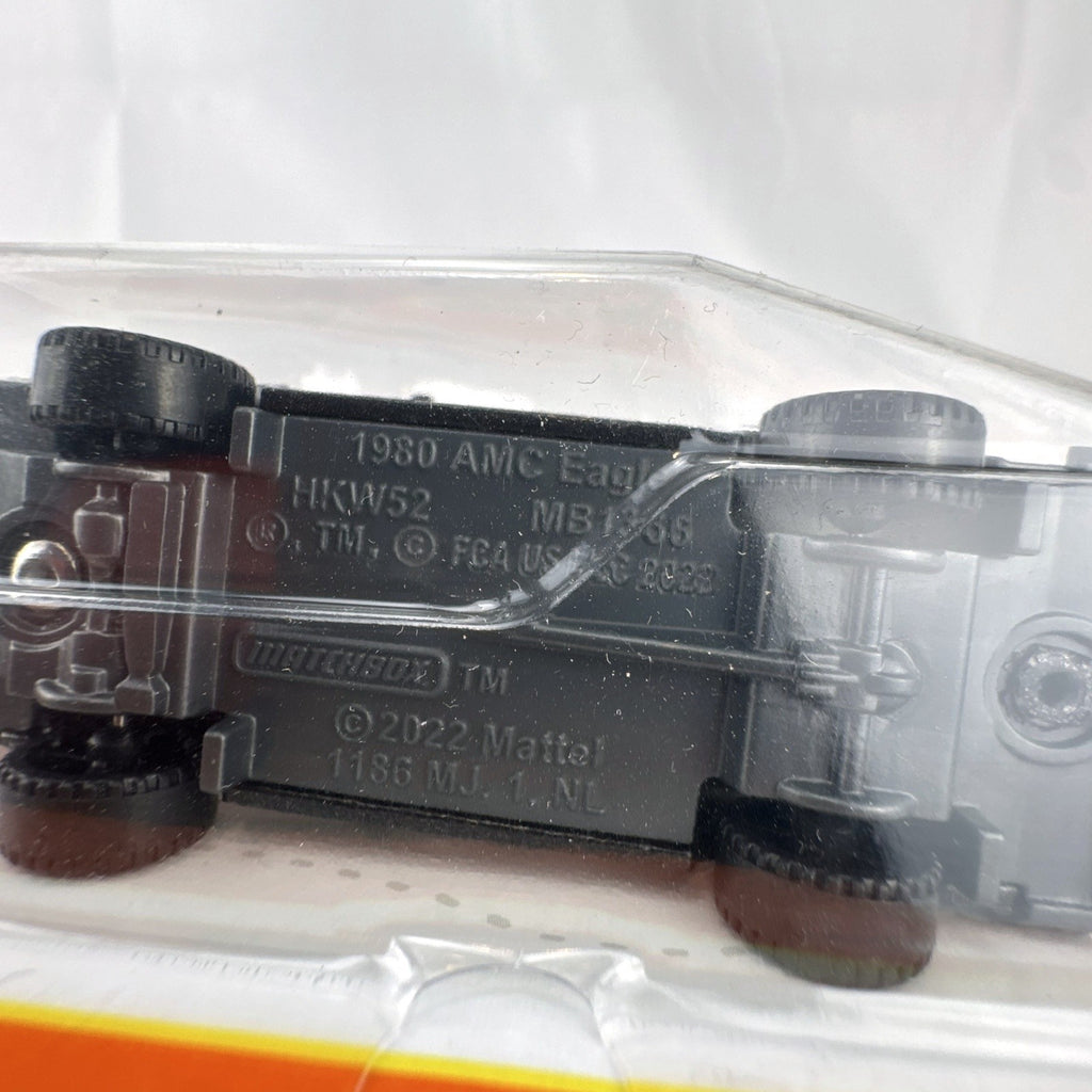 Matchbox 1:64 scale 1980 AMC Eagle diecast station wagon in black with woodgrain side panels sealed on card.