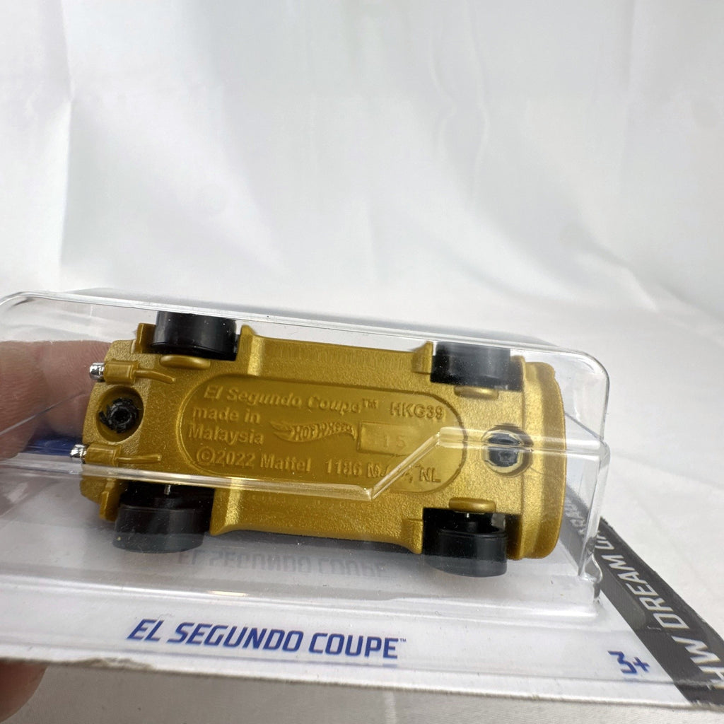 Hot Wheels 1:64 scale 2023 El Segundo Coupe diecast car in black with gold accents, factory sealed on card.
