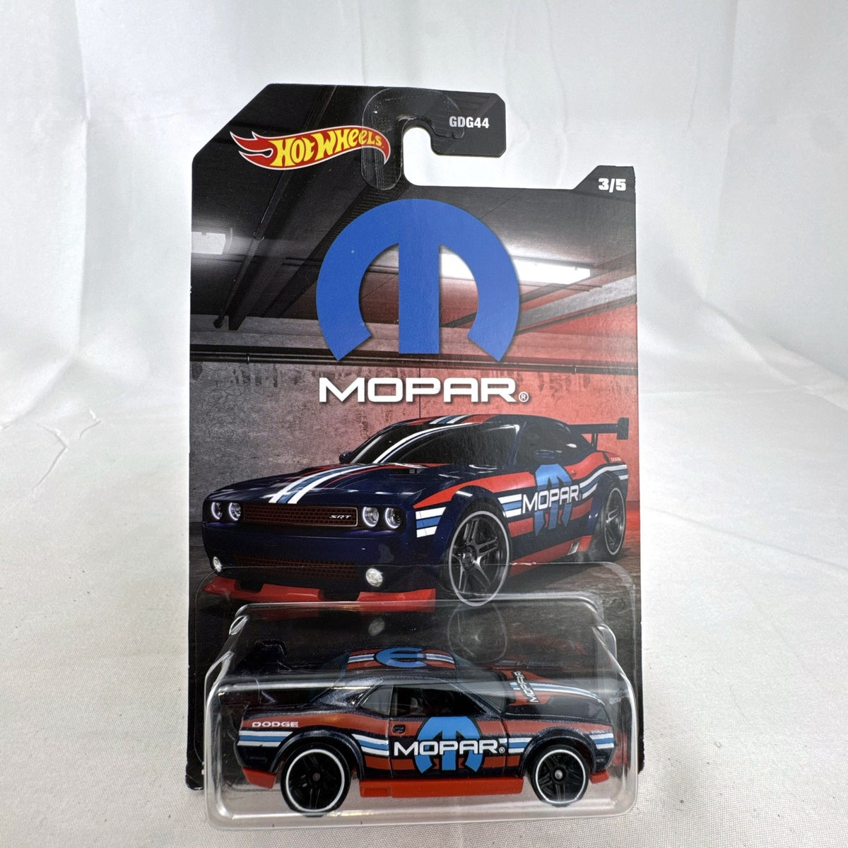 Sealed Hot Wheels 1:64 Dodge Challenger Drift Car in dark blue Mopar livery on original backing card.