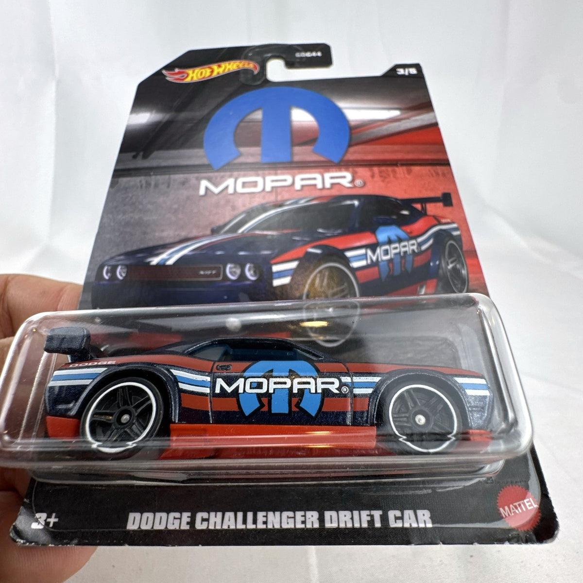 Sealed Hot Wheels 1:64 Dodge Challenger Drift Car in dark blue Mopar livery on original backing card.